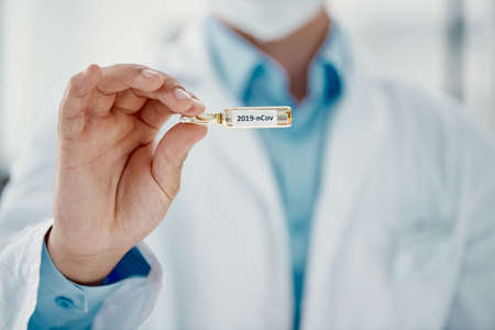 Its finally here. Cropped shot of a scientist holding an ampoule with 2019-nCov on it.の写真素材