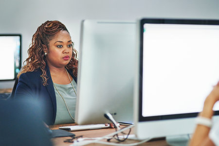 Shes always hard at work. Cropped shot of a businesswoman working in the office.の写真素材