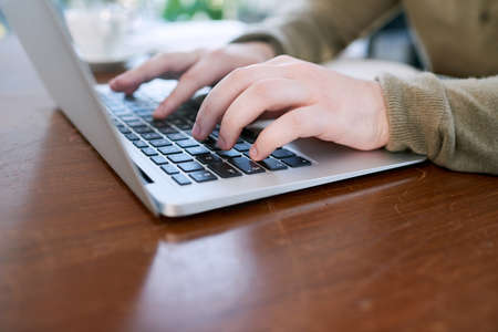 Start getting those deadlines done. Closeup shot of an unrecognisable businessman using a laptop in...