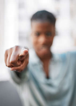 Words have power. Shot of an unrecognizable woman pointing with her hand outside.の写真素材