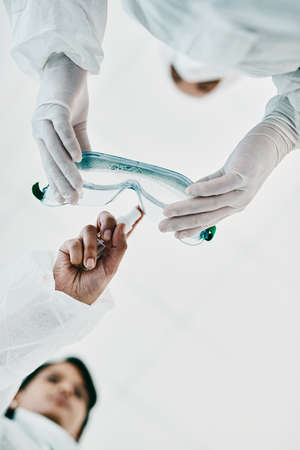 Everything we do determines the outcome. Cropped shot of two healthcare workers disinfecting...