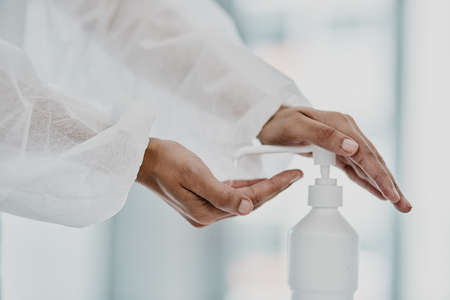 Stay sanitised, stay safe. Cropped shot of a healthcare worker disinfecting herself with hand...