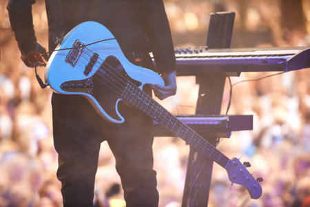 Tools of the musical trade. A performer standing with his guitar in front of a keyboard facing the audience.の写真素材