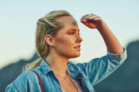 Look out there and see the beauty of nature. Cropped shot of a young beautiful woman in nature.