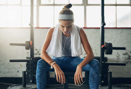 I can and I will. Shot of a young attractive woman resting in a gym.の写真素材