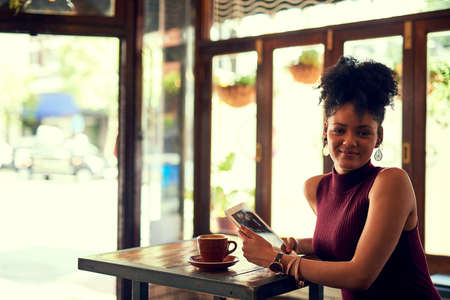 I guess you could say Im a social media guru. Portrait of an attractive young woman using a digital...