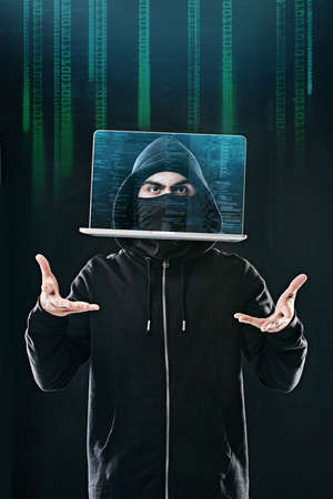 Bending your data to his will. Portrait of a computer hacker levitating a laptop while standing...
