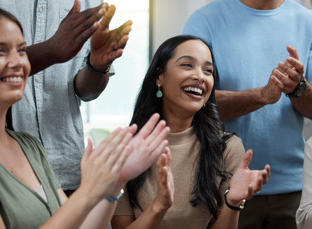 Wow, Im impressed. Shot of a young businesswoman applauding with her colleagues in an office.の写真素材