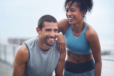 The journey were taking has been so rewarding. Shot of a sporty young couple taking a break while exercising outdoors.の写真素材