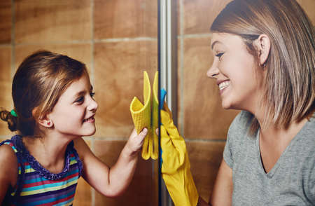 Its clean only once we can see each other clearly. Cropped shot of a mother and her little daughter cleaning a bathroom together at home.の写真素材
