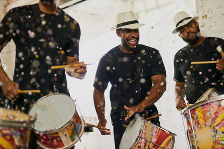 Their beats will keep you moving and grooving. Shot of a group of musical performers playing together indoors.の写真素材