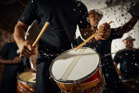 Feeling the rhythm in the drums. Closeup shot of a musical performer playing drums with his band.の写真素材