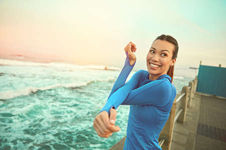Check off those goals one by one. Shot of a sporty young woman stretching before her run.