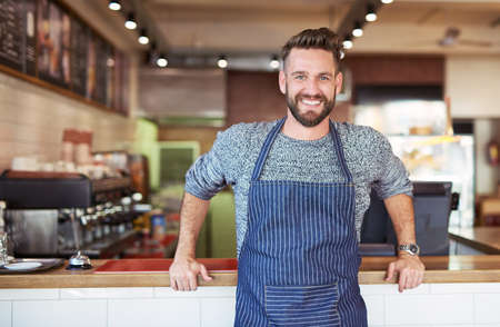 Building my coffee empire. Portrait of a proud business owner standing in his cafe.