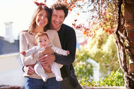 Their little bundle of joy. A portrait of a happy couple holding their baby outdoors.