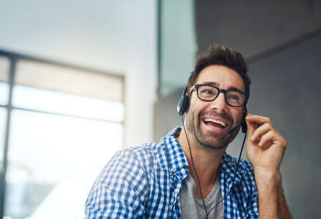 Answering a customer query. Cropped shot of a support agent working in a modern office.