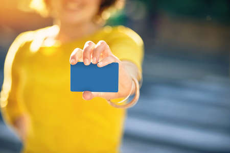 I prefer to pay with plastic. Shot of an unrecognizable young woman holding a credit card.の写真素材