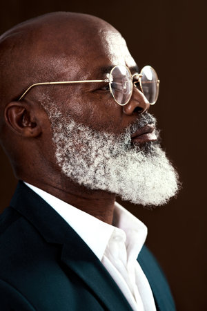 You can start working on a new dream at any age. Studio shot of a mature businessman posing against a brown background.の写真素材