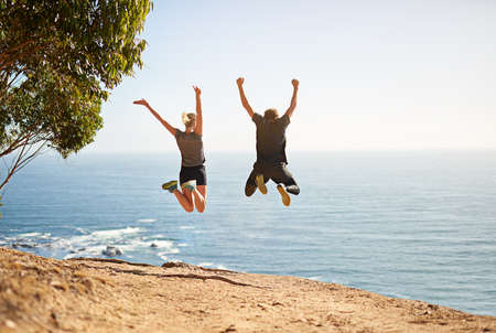 Dont make excuses, make results. Shot of a young couple jumping for joy after their workout.の写真素材