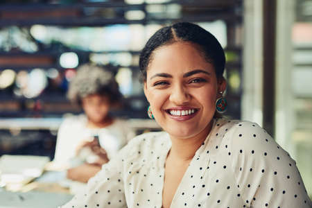 Shes determined to make the company a success. Cropped shot of designers having a meeting at a coffee shop.の写真素材
