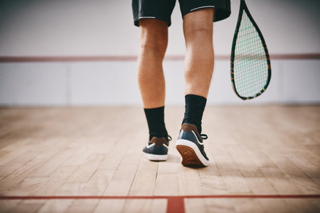 Youve now entered the league of champions. Cropped shot of an unrecognisable man playing a game of squash.の写真素材