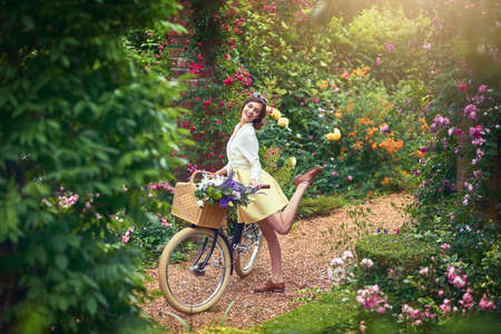 Being outdoors definitely puts a spring in my step. Shot of an attractive young woman riding a bicycle outdoors.の写真素材