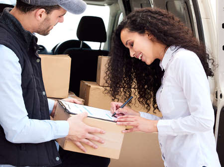 Its always exciting when your parcel arrives. Shot of a customer signing for her delivery from the...