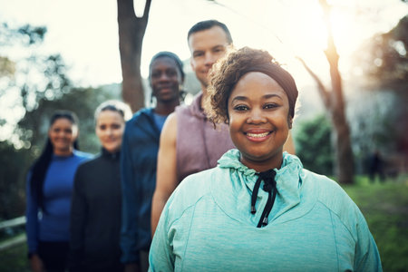 Happy that we all made it to the workout. Cropped shot of a sporty young group of friends working...