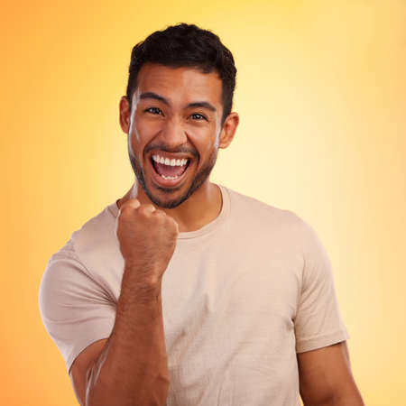 I told you got this. Shot of a young man looking cheerful while standing against a yellow background.の写真素材