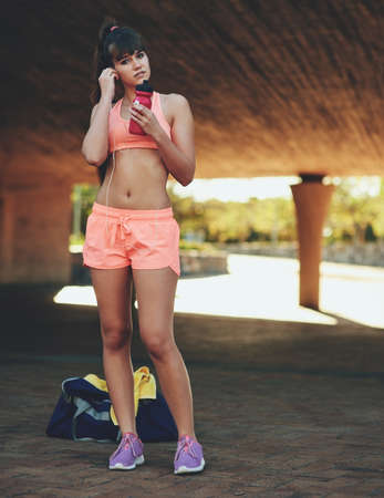 Fitness is a form of self-respect. Shot of a beautiful young woman out for her morning workout.の写真素材
