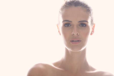 Perfect is the best way to describe her. Cropped shot of a beautiful young woman posing against a light background.の写真素材