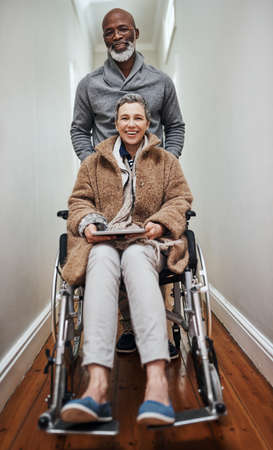 Were all smiles this side. Full length shot of a senior man pushing his wheelchair-bound wife...