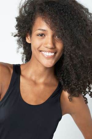 No weave needed. Portrait of a beautiful young ethnic woman isolated on white.の写真素材