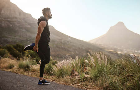 Today, we wont stumble. Shot of a sporty young man exercising outdoors.の写真素材