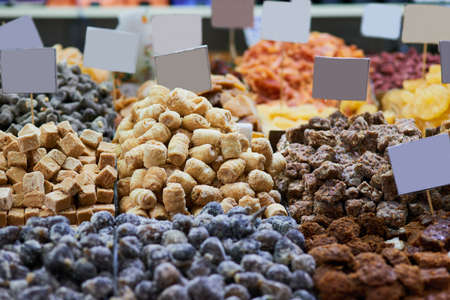 Wide variety or treats. Shot of a wide variety of different types of delicious treats at a market stall outside during the day.の写真素材