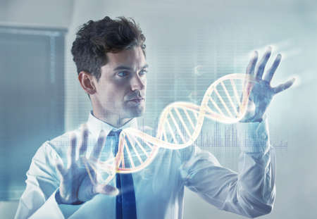 Shot of a young businessman using a cgi digital interface- ALL screen content on this image is created from scratch by Yuri Arcurs team of professionals for this particular photo shoot - this is an alternative version of iStock file 44832818.の写真素材