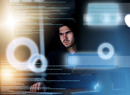 Hes the master of metadata. Shot of a focussed young computer programmer working on his coding late...