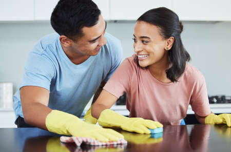 I love doing life with you. Shot of a young couple cleaning their kitchen together.の写真素材
