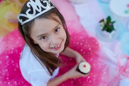 Every little girl should feel like a princess. Portrait of a little girl dressed up as a princess having a picnic outside.の写真素材