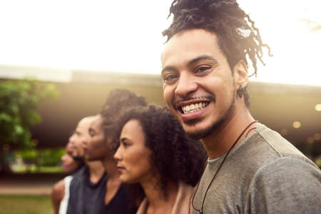 The public park is our hanging out spot. Cropped shot of a group of friends standing in a row in a...