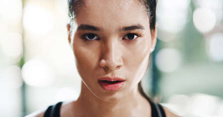 Bring it on. Cropped portrait of an attractive young sportswoman standing in a gym.の写真素材