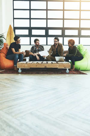 Keep an open mind when exploring new possibilities. Shot of a group of young designers discussing...