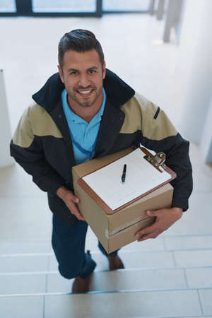 Our job is only done once youre satisfied. Portrait of a courier making a delivery in an office.