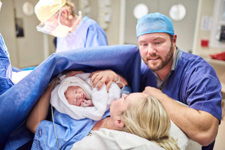 Shes perfect in every tiny way. Shot of a beautiful young couple welcoming their newly born baby...
