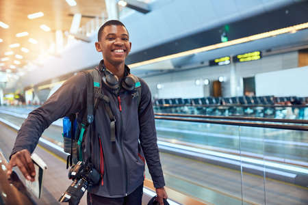 Getting more excited as we get closer. Shot of a moving walkway in the airport.の写真素材
