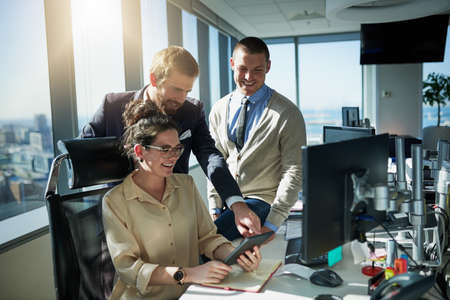 We all have a say in the work. Shot of a group of young businesspeople working together on a...
