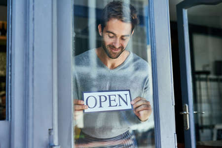 Proud shop owner. Cropped shot of a handsome young cafe owner.の写真素材