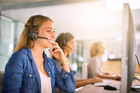 Solving problems one by one. Cropped shot of a group of young women working in a call center.