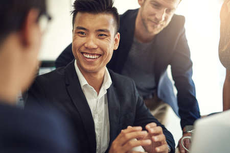 Passionate about design. Shot of a group of coworkers having a discussion in a boardroom.の写真素材