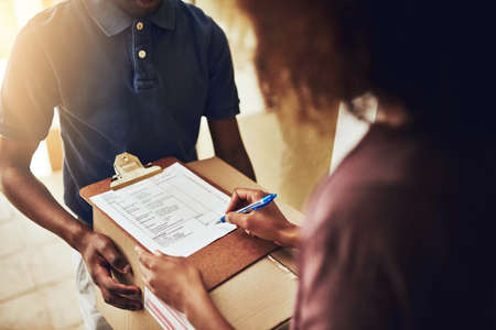 All you have to do is sign for it. High angle shot of an unrecognizable woman signing for a home...